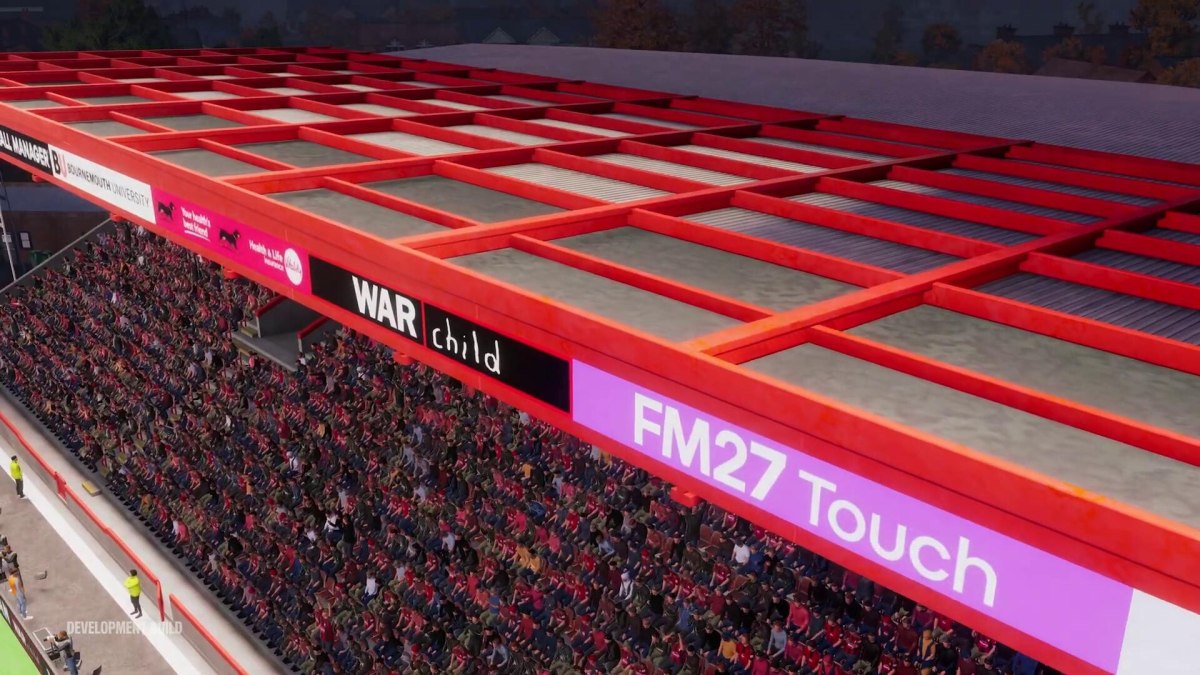Bancada com publicidade na cobertura num estádio do FM27